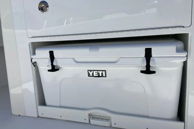 Slide: The Image of YETI cooler stored in a 2026 Regulator 28 boat compartment. - 5