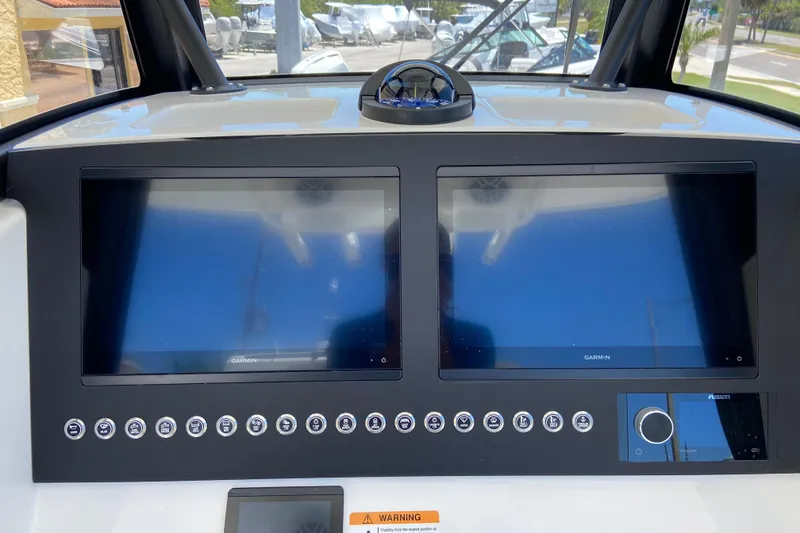 Slide: The Image of 2026 Regulator 28 boat dashboard with dual Garmin displays and control panel. - 6