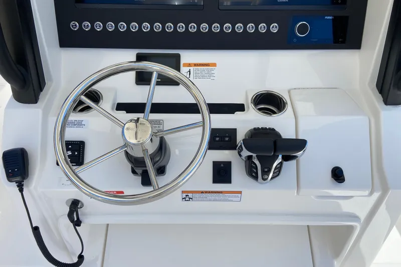 Slide: The Image of Helm of 2026 Regulator 28 boat with steering wheel and controls. - 7