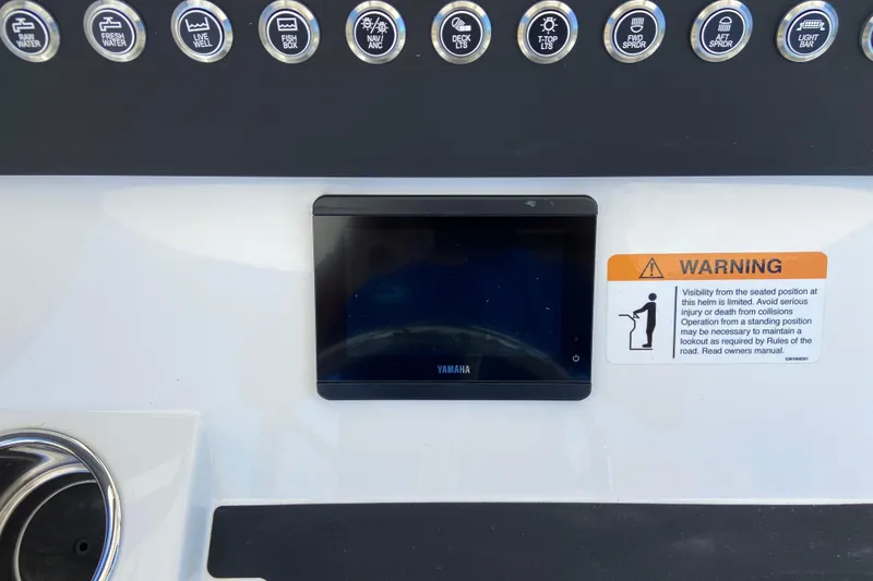 Slide: The Image of Control panel of 2026 Regulator 28 boat with Yamaha display and warning label. - 8