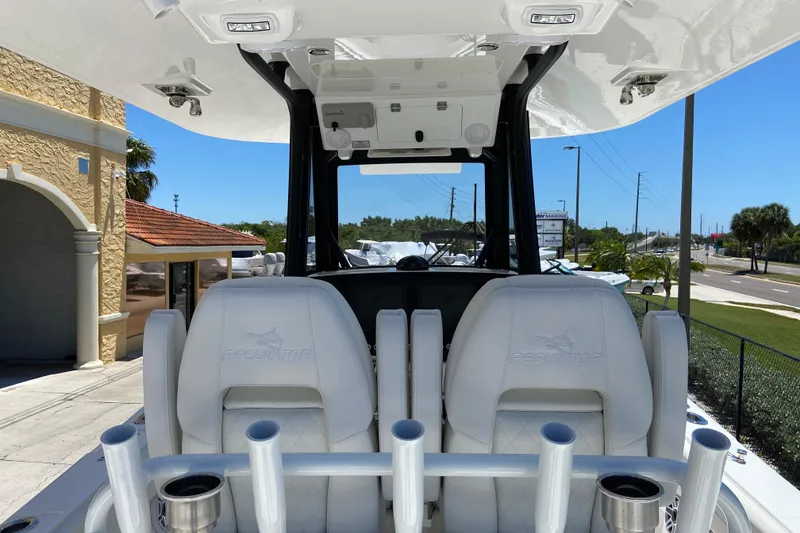 Slide: The Image of 2026 Regulator 28 boat interior with white seats and rod holders. - 9