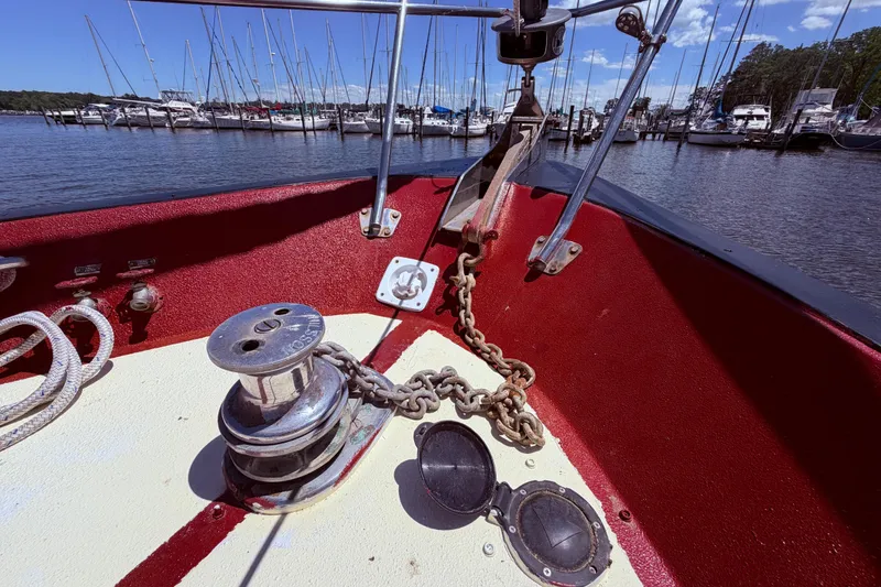 Slide: The Image of Bow of 1985 Lancer Yachts 40 Motorsailer with anchor chain and marina view. - 13