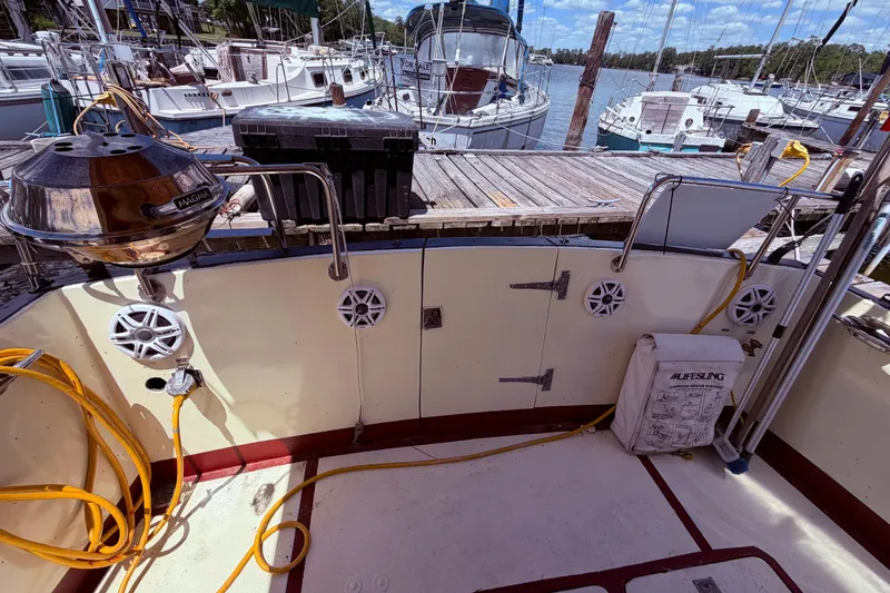 Slide: The Image of Cockpit of 1985 Lancer Yachts 40 Motorsailer with grill and lifesaving equipment at dock. - 16