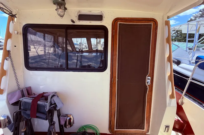 Slide: The Image of 1985 Lancer Yachts 40 Motorsailer cabin entrance with window and wooden door. - 21