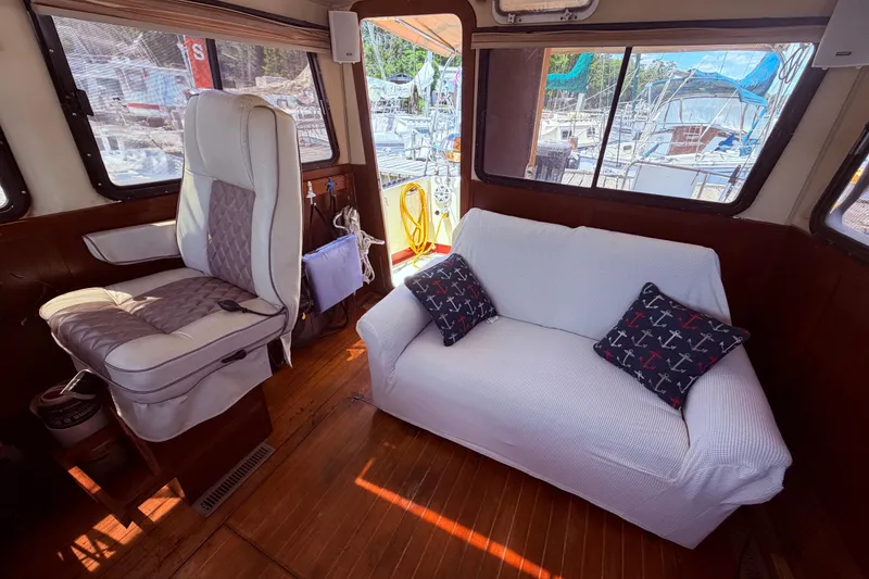 Slide: The Image of Interior of 1985 Lancer Yachts 40 Motorsailer with seating and nautical-themed cushions. - 24
