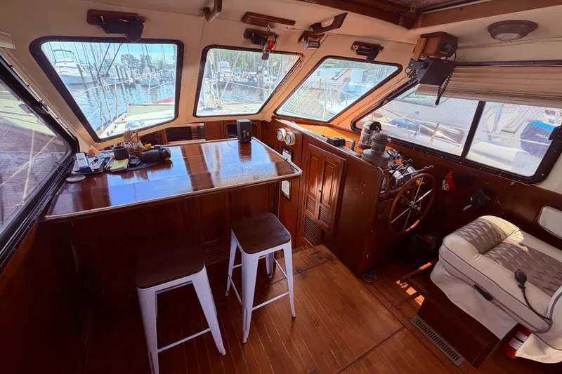Slide: The Image of Interior of 1985 Lancer Yachts 40 Motorsailer with wooden helm and seating area. - 27