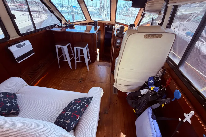 Slide: The Image of Interior of 1985 Lancer Yachts 40 Motorsailer with captain's chair and cozy seating area. - 30