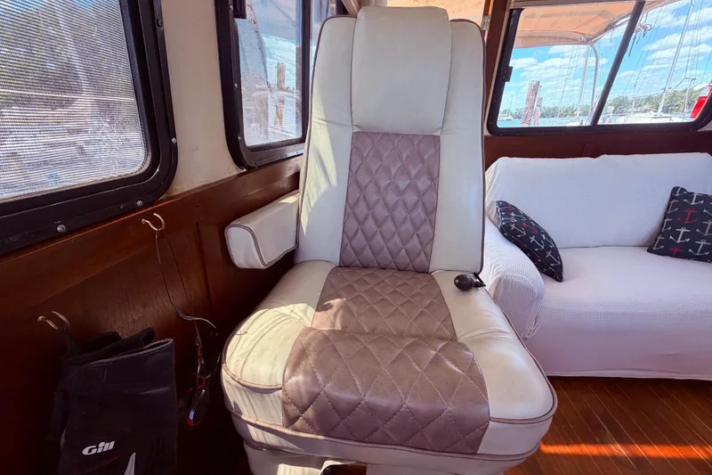 Slide: The Image of Interior of 1985 Lancer Yachts 40 Motorsailer with cushioned seating and nautical decor. - 32