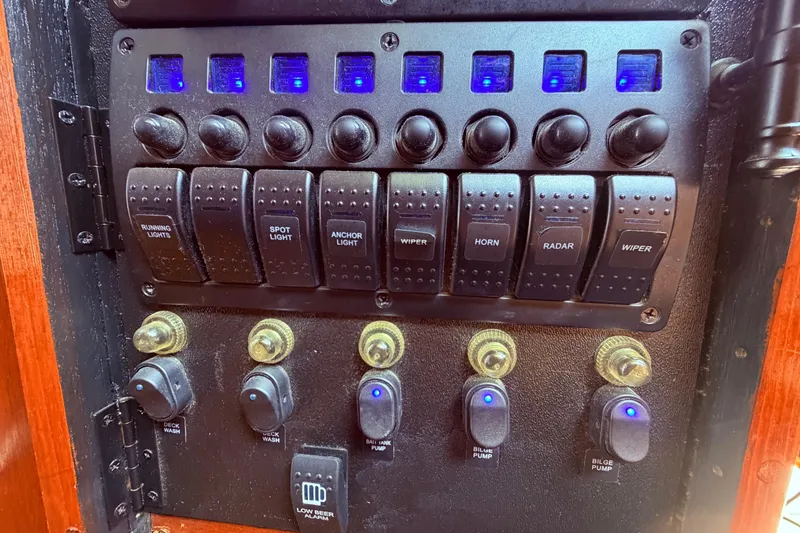 Slide: The Image of Control panel of a 1985 Lancer Yachts 40 Motorsailer with labeled switches and buttons. - 50