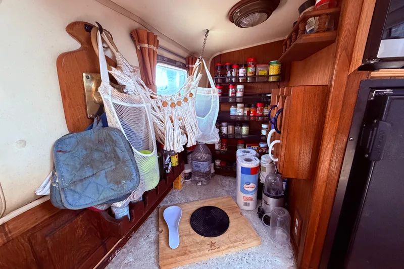 Slide: The Image of Cozy kitchen area in a 1985 Lancer Yachts 40 Motorsailer, featuring spices and kitchen essentials. - 52