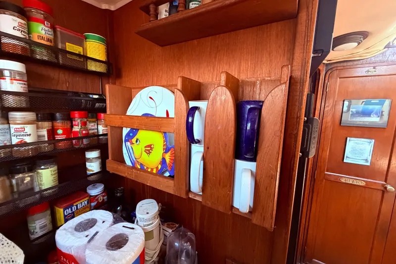 Slide: The Image of Interior of 1985 Lancer Yachts 40 Motorsailer with spice rack and colorful dishware. - 53