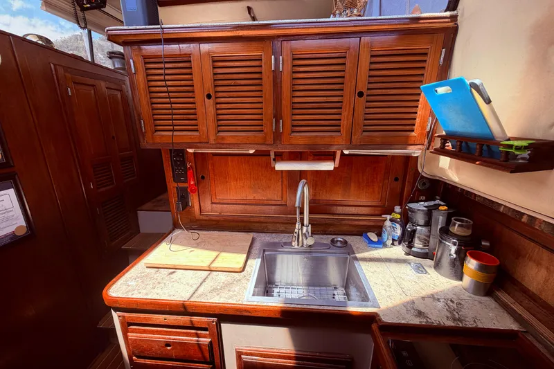Slide: The Image of Cozy kitchen in 1985 Lancer Yachts 40 Motorsailer with wooden cabinets and modern appliances. - 62