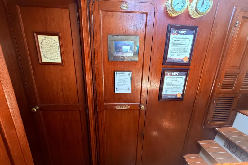 Slide: The Image of Interior of 1985 Lancer Yachts 40 Motorsailer with wooden paneling and framed certificates. - 65