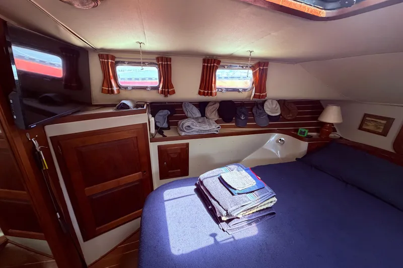 Slide: The Image of Cozy cabin interior of 1985 Lancer Yachts 40 Motorsailer with bed and wooden cabinetry. - 75