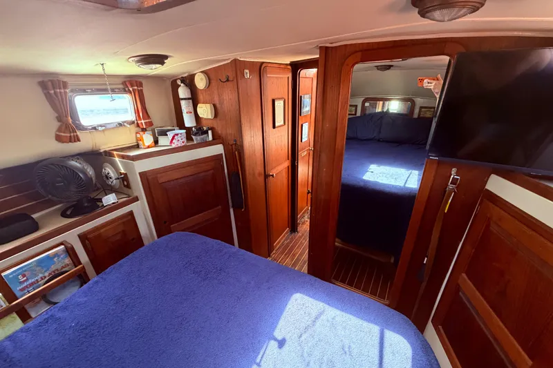 Slide: The Image of Interior of 1985 Lancer Yachts 40 Motorsailer with wood paneling and cozy cabin. - 77