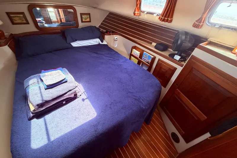 Slide: The Image of Cozy cabin interior of 1985 Lancer Yachts 40 Motorsailer with bed and wooden accents. - 81