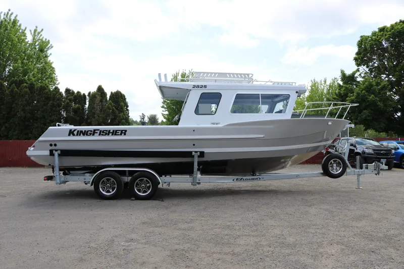 The Image of 2026 KingFisher 2825 Coastal Express boat on trailer, parked outdoors. - 0