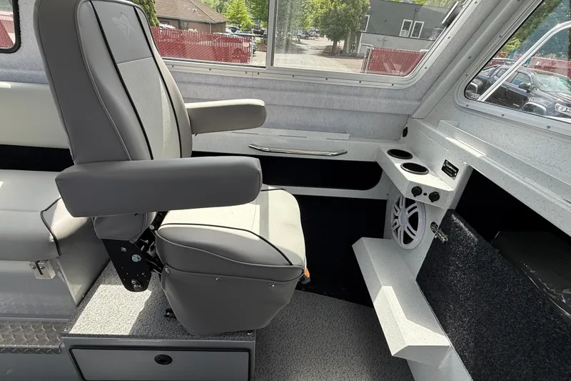 Slide: The Image of Interior of 2026 KingFisher 2825 Coastal Express boat with gray seating and cup holders. - 10