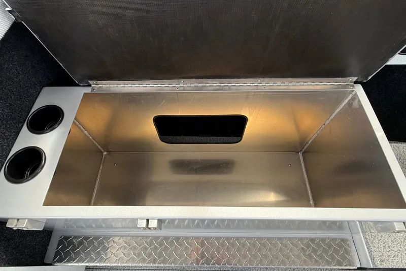Slide: The Image of Open storage compartment in 2026 KingFisher 2825 Coastal Express boat, featuring cup holders. - 13