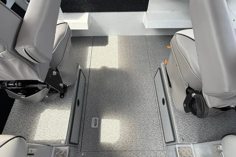 Slide: The Image of Interior view of 2026 KingFisher 2825 Coastal Express boat with gray seating and flooring. - 14