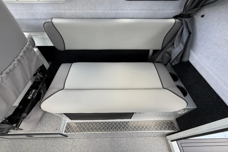 Slide: The Image of Interior seating of 2026 KingFisher 2825 Coastal Express boat, featuring cushioned bench and cup holders. - 17
