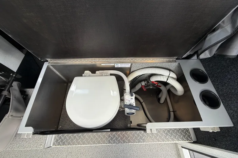 Slide: The Image of 2026 KingFisher 2825 Coastal Express boat toilet compartment with plumbing and storage features. - 18