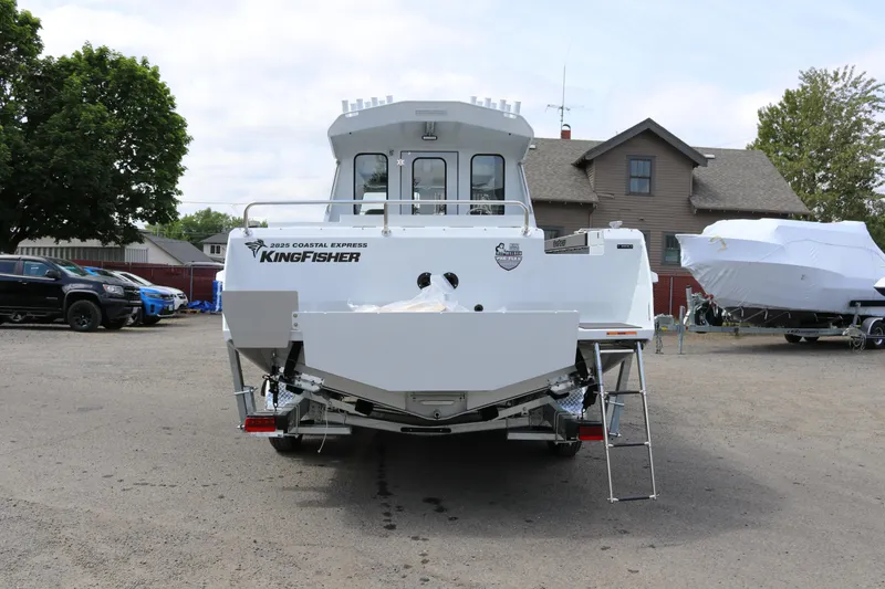 Slide: The Image of 2026 KingFisher 2825 Coastal Express boat parked outdoors, rear view. - 2