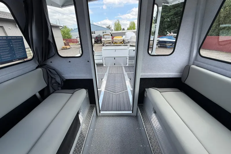 Slide: The Image of Interior of 2026 KingFisher 2825 Coastal Express boat, featuring seating and deck view. - 20