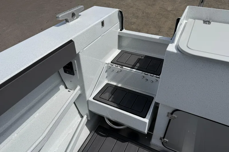 Slide: The Image of Interior view of 2026 KingFisher 2825 Coastal Express boat, featuring sleek storage compartments. - 21