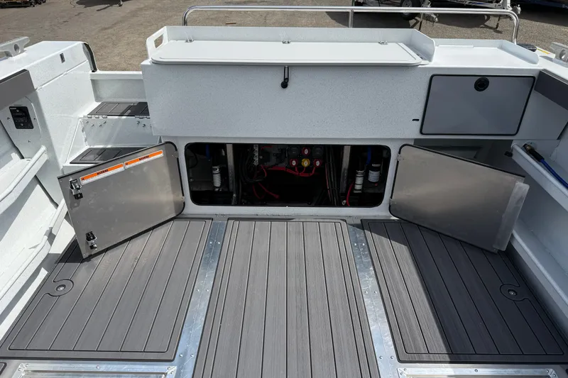 Slide: The Image of Interior view of 2026 KingFisher 2825 Coastal Express boat with open storage compartments. - 23