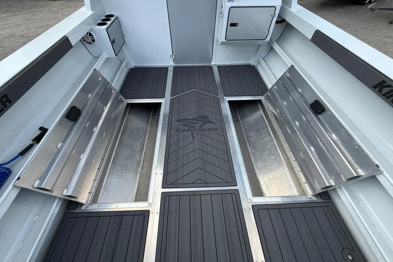 Slide: The Image of Interior view of 2026 KingFisher 2825 Coastal Express boat with storage compartments open. - 26