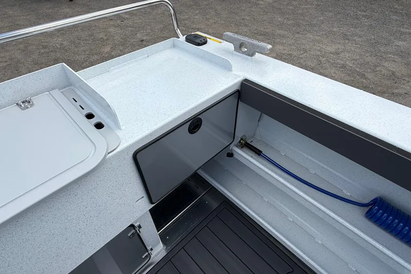 Slide: The Image of Interior view of 2026 KingFisher 2825 Coastal Express boat, featuring storage and utility areas. - 28