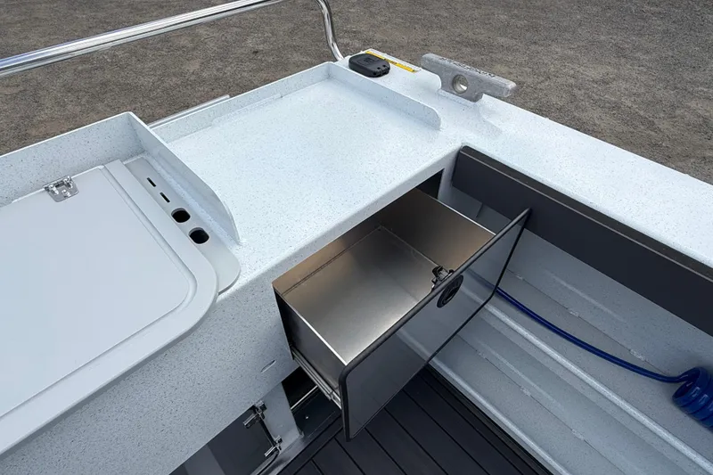 Slide: The Image of Interior view of 2026 KingFisher 2825 Coastal Express boat with storage compartment open. - 29