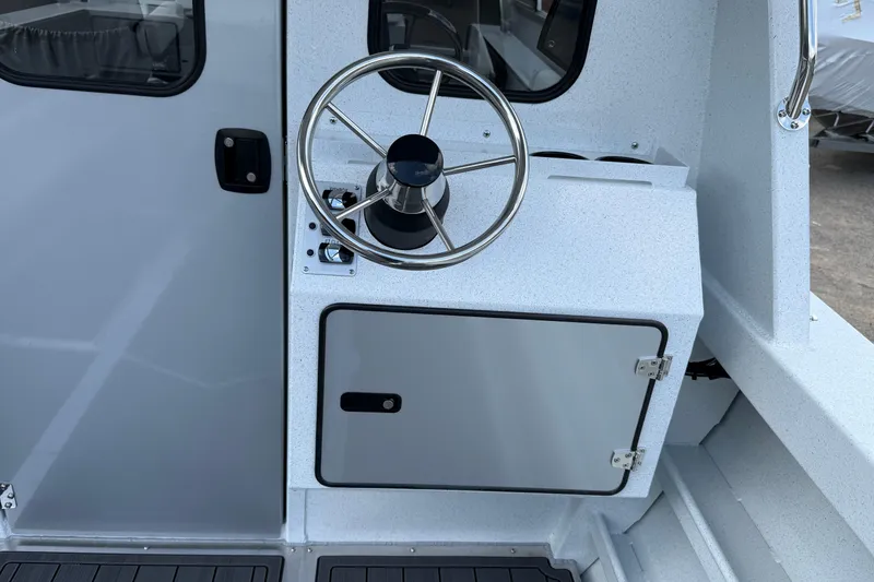 Slide: The Image of Steering wheel and control panel of 2026 KingFisher 2825 Coastal Express boat. - 30