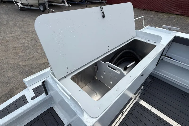 Slide: The Image of Open storage compartment on 2026 KingFisher 2825 Coastal Express boat, showcasing interior space. - 32