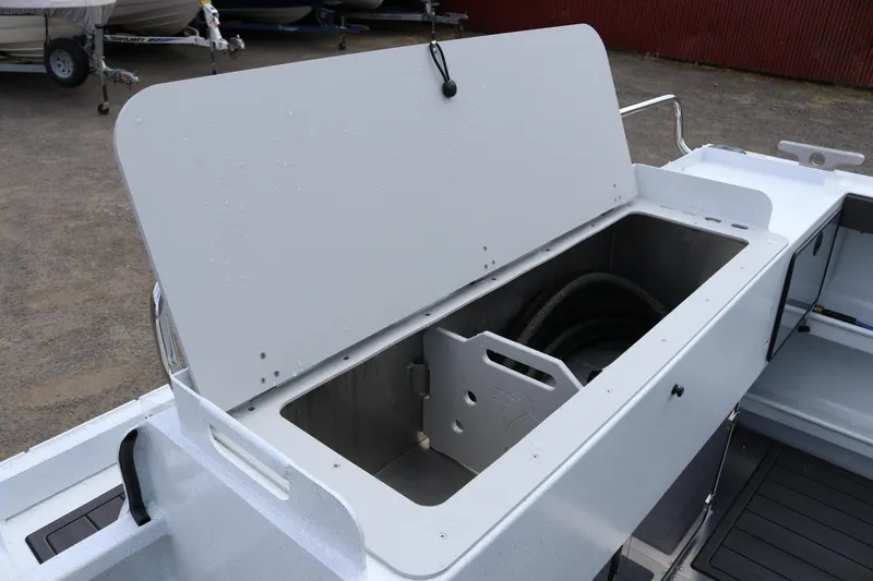 Slide: The Image of Open storage compartment on 2026 KingFisher 2825 Coastal Express boat. - 33