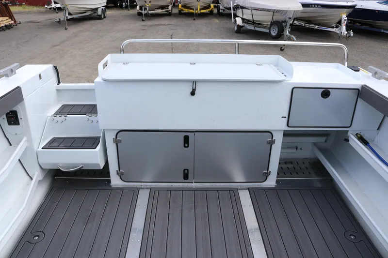 Slide: The Image of Interior view of 2026 KingFisher 2825 Coastal Express boat, showcasing storage compartments and seating. - 35