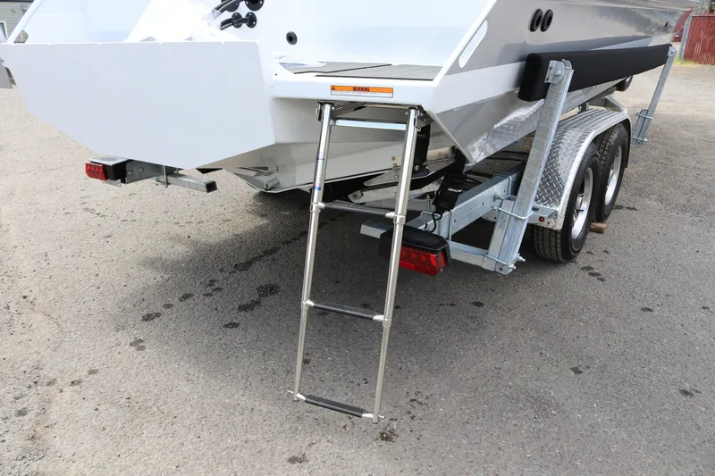 Slide: The Image of 2026 KingFisher 2825 Coastal Express boat trailer with ladder and dual axle wheels. - 38