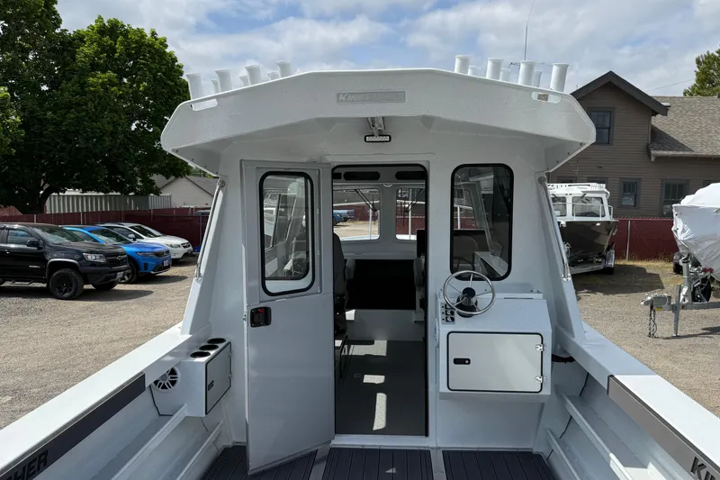 Slide: The Image of 2026 KingFisher 2825 Coastal Express boat with open cabin and steering wheel. - 5