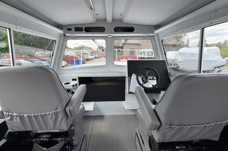 Slide: The Image of Interior of 2026 KingFisher 2825 Coastal Express boat with dual seats and steering console. - 7