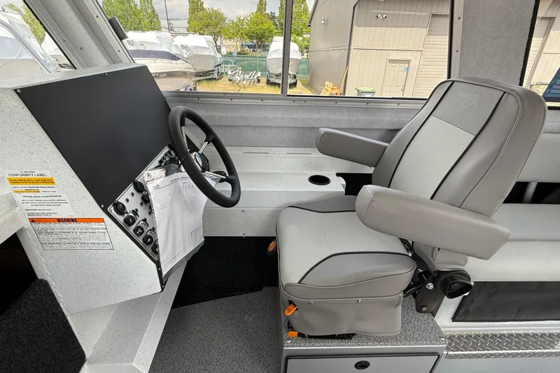 Slide: The Image of Interior of 2026 KingFisher 2825 Coastal Express boat with steering wheel and captain's chair. - 8