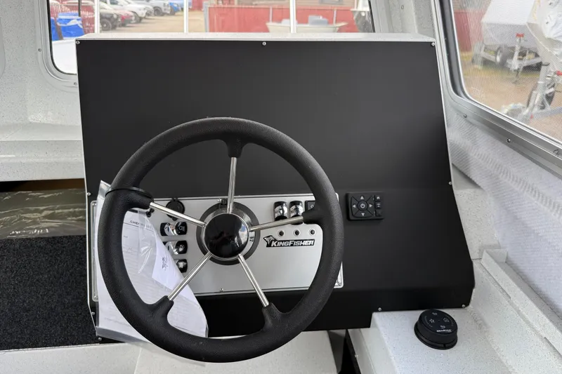 Slide: The Image of Steering console of 2026 KingFisher 2825 Coastal Express boat, featuring modern controls. - 9