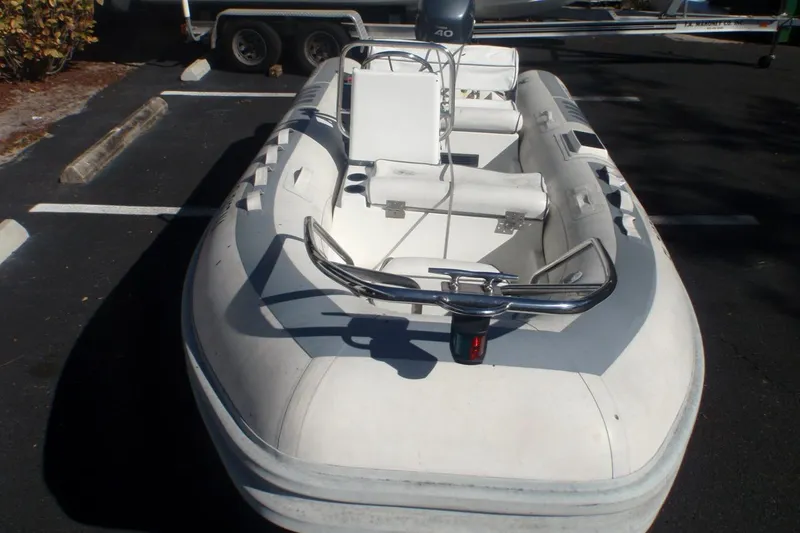 Slide: The Image of 2003 Novurania DL 400 inflatable boat with seating, parked on asphalt. - 3