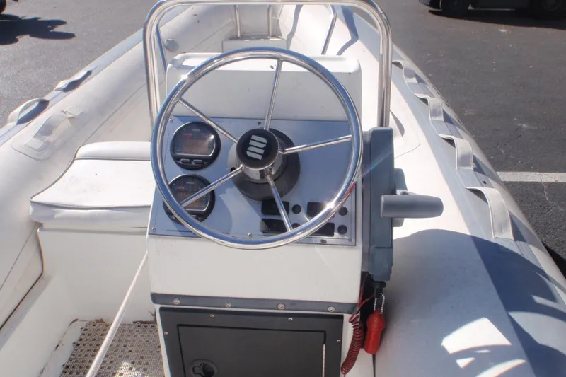 Slide: The Image of 2003 Novurania DL 400 boat steering console with gauges and controls. - 5