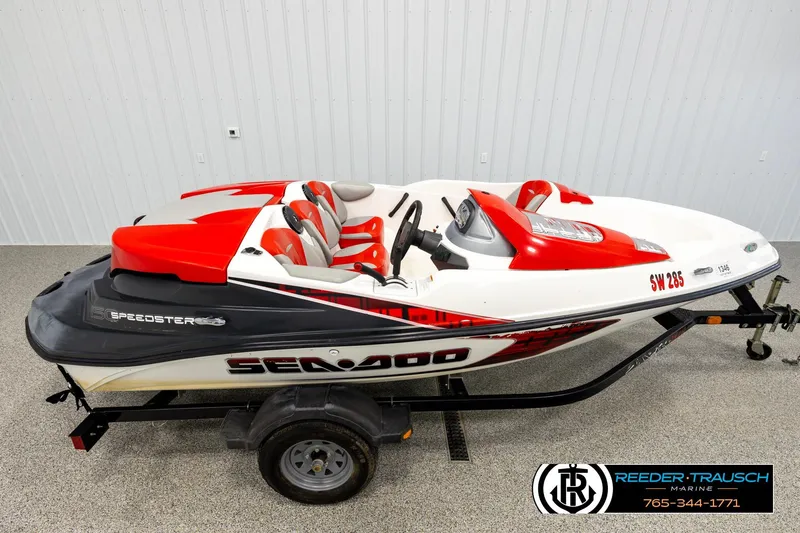 The Image of 2007 Sea Doo 150 Speedster boat with red and white design on a trailer. - 1