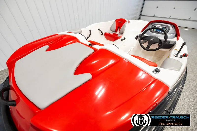 Slide: The Image of 2007 Sea Doo 150 Speedster boat interior with red and white seating, steering wheel, and dashboard. - 11