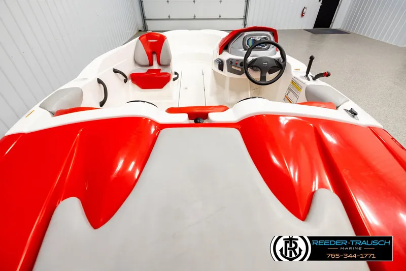 Slide: The Image of 2007 Sea Doo 150 Speedster boat interior with red and white seating, steering wheel, and controls. - 12
