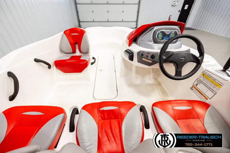 Slide: The Image of 2007 Sea Doo 150 Speedster interior with red and gray seating, steering wheel, and dashboard. - 13