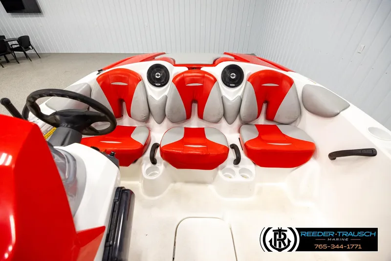 Slide: The Image of 2007 Sea Doo 150 Speedster interior with red and gray seating, steering wheel, and cup holders. - 16