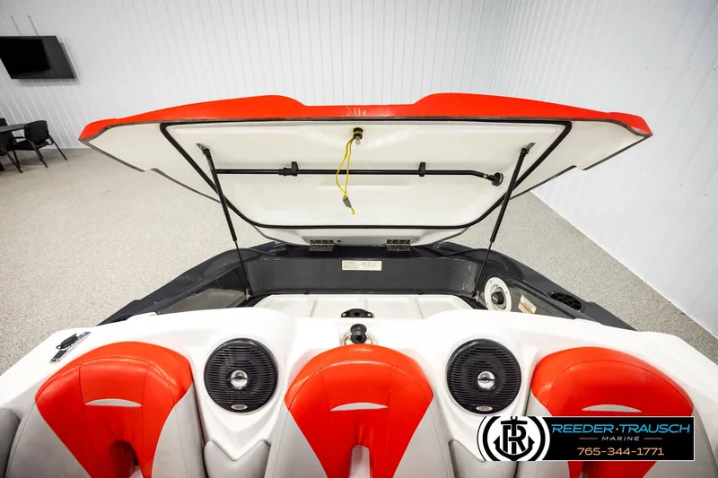 Slide: The Image of 2007 Sea Doo 150 Speedster interior with open engine compartment, red and white seating. - 18